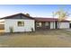 Inviting home exterior with brick and siding, a well-kept lawn, and mature trees at 4410 N 20Th Ave, Phoenix, AZ 85015