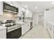 Bright kitchen featuring stainless steel appliances, white cabinets, and chevron backsplash at 4410 N 20Th Ave, Phoenix, AZ 85015