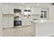 Well-lit kitchen with white cabinets, stainless steel appliances, and stylish backsplash at 4410 N 20Th Ave, Phoenix, AZ 85015