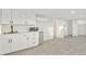 Modern kitchenette with white cabinets, stainless steel mini fridge, and stylish fixtures at 4410 N 20Th Ave, Phoenix, AZ 85015