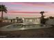 Backyard pool and patio with palm trees and updated home exterior at dusk at 4410 N 20Th Ave, Phoenix, AZ 85015