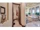 En-suite bathroom boasts a soaking tub, tile surround, and natural light from large windows at 4431 E Gemini Pl, Chandler, AZ 85249