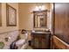 Powder room with custom vanity, carved mirror, and elegant fixtures at 4431 E Gemini Pl, Chandler, AZ 85249