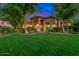 Charming front yard featuring lush green lawn and mature trees, leading to a welcoming entrance at 4431 E Gemini Pl, Chandler, AZ 85249