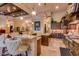 Open-concept kitchen includes a breakfast bar, granite countertops and custom cabinetry at 4431 E Gemini Pl, Chandler, AZ 85249