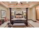 Spacious main bedroom with a four-poster bed, sitting area, and custom lighting at 4431 E Gemini Pl, Chandler, AZ 85249