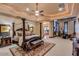 Spacious main bedroom with a four-poster bed, sitting area, and custom lighting at 4431 E Gemini Pl, Chandler, AZ 85249