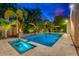 Stunning backyard with a sparkling pool, spa, and rock waterfall feature, surrounded by lush landscaping at 4431 E Gemini Pl, Chandler, AZ 85249