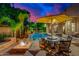 Outdoor fire pit and pool area, perfect for entertaining, with comfortable seating and ambient lighting at 4431 E Gemini Pl, Chandler, AZ 85249