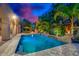 Serene pool and spa area with covered patio and outdoor dining, surrounded by palm trees and lush greenery at 4431 E Gemini Pl, Chandler, AZ 85249