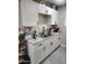 Bright kitchen featuring granite countertops, white cabinets, and a stainless steel sink at 4610 W Indianola Ave, Phoenix, AZ 85031