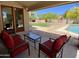 Cozy covered back patio with views of the fenced yard and sparkling pool at 4750 W Saddlehorn Rd, Phoenix, AZ 85083