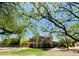 Expansive backyard showcasing lush greenery, a pool, and the home's exterior at 4750 W Saddlehorn Rd, Phoenix, AZ 85083