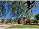 Inviting backyard featuring a pool, lush green lawn, and a lovely two-story home at 4750 W Saddlehorn Rd, Phoenix, AZ 85083