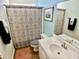 Well-maintained bathroom featuring a patterned shower curtain and a clean vanity with modern fixtures at 4750 W Saddlehorn Rd, Phoenix, AZ 85083