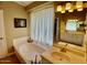 Bathroom with a soaking tub, white vanity, and a decorative mirror at 4750 W Saddlehorn Rd, Phoenix, AZ 85083
