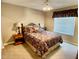 Bedroom features carpet flooring, side table, ceiling fan, and natural light from the window at 4750 W Saddlehorn Rd, Phoenix, AZ 85083