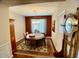 This cozy dining room has a charming chandelier, a dark accent wall, and traditional furnishings at 4750 W Saddlehorn Rd, Phoenix, AZ 85083