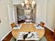Dining room featuring hardwood floors, a round table set for four, and views into the living room at 4750 W Saddlehorn Rd, Phoenix, AZ 85083