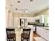 Bright kitchen with stainless steel appliances, white cabinetry, granite countertops, and a center island with seating at 4750 W Saddlehorn Rd, Phoenix, AZ 85083