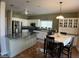 Open kitchen with granite counters, stainless appliances, and an eat-in dining area at 4750 W Saddlehorn Rd, Phoenix, AZ 85083