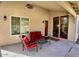 Covered patio area with red patio furniture, exterior lighting, and tiled flooring at 4750 W Saddlehorn Rd, Phoenix, AZ 85083