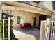 Covered patio area with red patio furniture, exterior lighting, and tile roof at 4750 W Saddlehorn Rd, Phoenix, AZ 85083