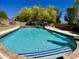 Inviting swimming pool with blue water, surrounded by lush landscaping and poolside seating at 4750 W Saddlehorn Rd, Phoenix, AZ 85083