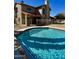 Back of house view features a sparkling pool, privacy fence, and covered patio at 4750 W Saddlehorn Rd, Phoenix, AZ 85083
