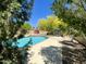 Relaxing pool area with poolside furniture and mature trees creating a private, shaded retreat at 4750 W Saddlehorn Rd, Phoenix, AZ 85083