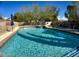 Sparkling pool with sun loungers and blue umbrellas is ready for summer fun at 4750 W Saddlehorn Rd, Phoenix, AZ 85083