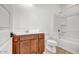 Bathroom featuring wooden vanity and shower-tub combo at 5544 W Saint Moritz Ln, Glendale, AZ 85306