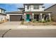 Charming two-story home with a vibrant turquoise front door, attractive landscaping and a dark wood-grain garage door at 5544 W Saint Moritz Ln, Glendale, AZ 85306