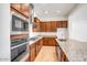 Contemporary kitchen featuring stainless steel appliances, granite countertops, and extensive wood cabinetry at 5544 W Saint Moritz Ln, Glendale, AZ 85306