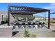 Community outdoor kitchen featuring a grill and counter seating, perfect for entertaining and enjoying the outdoors at 5544 W Saint Moritz Ln, Glendale, AZ 85306