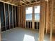 Bedroom framing with visible wall insulation, window placement, and the concrete flooring base at 5610 W Olney Ave, Laveen, AZ 85339