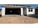 Exterior framing of a new home construction with the garage, window framing, and roofing materials at 5610 W Olney Ave, Laveen, AZ 85339
