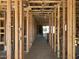 Interior framing of a new home construction showcasing the hallway with wiring and fixture placements at 5610 W Olney Ave, Laveen, AZ 85339