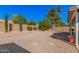 Large backyard with gravel landscaping, privacy fence and mature trees providing shade at 5622 E Gelding Dr, Scottsdale, AZ 85254
