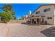Spacious backyard features a covered patio, gravel landscaping, and mature trees providing shade at 5622 E Gelding Dr, Scottsdale, AZ 85254