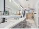 Bright bathroom with a large double vanity, modern lighting, and a shower-tub combo at 5622 E Gelding Dr, Scottsdale, AZ 85254