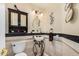 Charming powder room features a decorative pedestal sink and stylish wall accents at 5622 E Gelding Dr, Scottsdale, AZ 85254