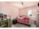 Bright bedroom featuring ceiling fan, pink walls, shutters on windows and carpeted floors at 5622 E Gelding Dr, Scottsdale, AZ 85254