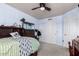 Bright bedroom featuring a ceiling fan, an aquarium, and a bed with a built-in bookcase headboard at 5622 E Gelding Dr, Scottsdale, AZ 85254