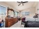 Spacious bedroom featuring a ceiling fan, dual windows, and a vintage vanity at 5622 E Gelding Dr, Scottsdale, AZ 85254