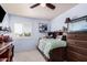 Light-filled bedroom with a ceiling fan, a desk, and a built-in bookcase bedframe with whimsical decorative touches at 5622 E Gelding Dr, Scottsdale, AZ 85254