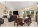 Elegant dining room with a fireplace, television, and beautiful table set at 5622 E Gelding Dr, Scottsdale, AZ 85254