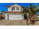 Inviting home exterior with a two-car garage, mature palm trees, and beautiful curb appeal at 5622 E Gelding Dr, Scottsdale, AZ 85254