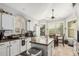 Bright kitchen with white cabinets, an island, granite countertops, and an eat-in area at 5622 E Gelding Dr, Scottsdale, AZ 85254