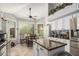 Eat-in kitchen with granite island, stainless steel appliances, tile floor, and modern fixtures at 5622 E Gelding Dr, Scottsdale, AZ 85254